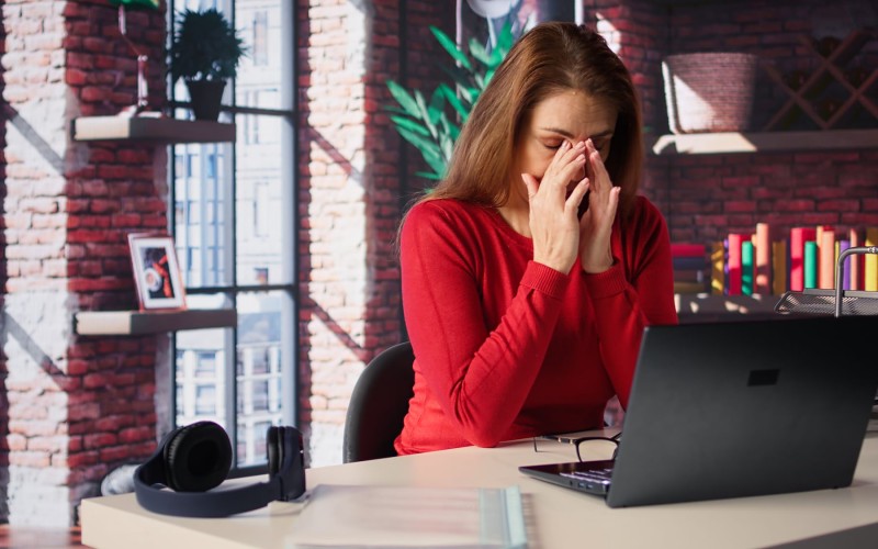 stressed-woman-home-desk-battling-job-burnout-exhaustion.jpg
